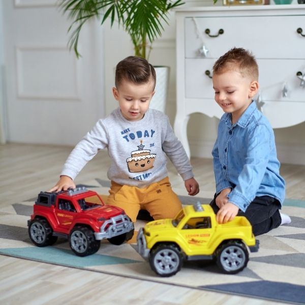 two preschool boys playing with trucks