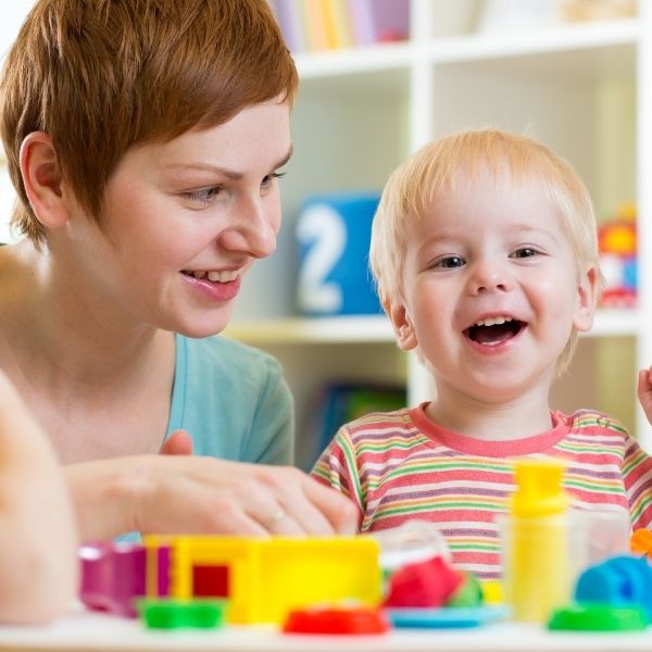 a child smiling with a teacher