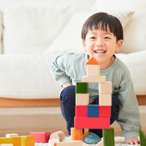 a child stacking blocks