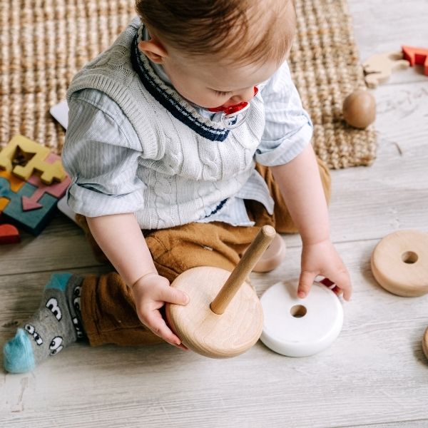 an infant stacking objects